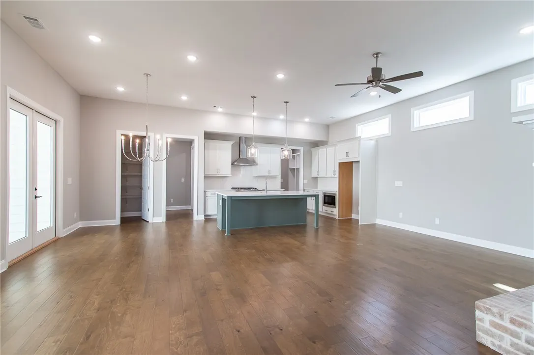 This expansive open-concept living area seamlessly connects to a modern kitchen, creating an ideal space for daily life.Photos are not of subject property. Photos are of the same floorplan of a completed home.