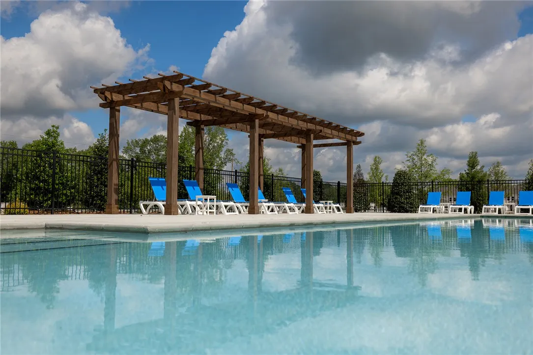 Relax poolside under the inviting pergola, offering a refreshing retreat on warm days.