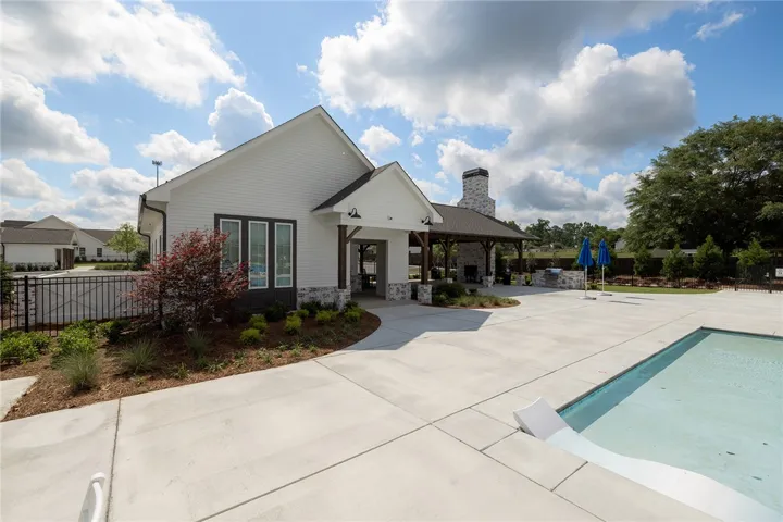 This modern clubhouse features an inviting outdoor area with a refreshing pool.