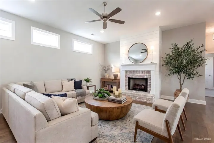 This inviting living area boasts a warm fireplace and rich hardwood flooring, perfect for comfortable gatherings.