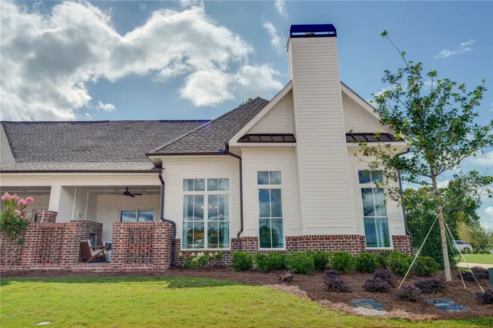 This charming home showcases a classic exterior with modern architectural accents and an inviting covered patio.