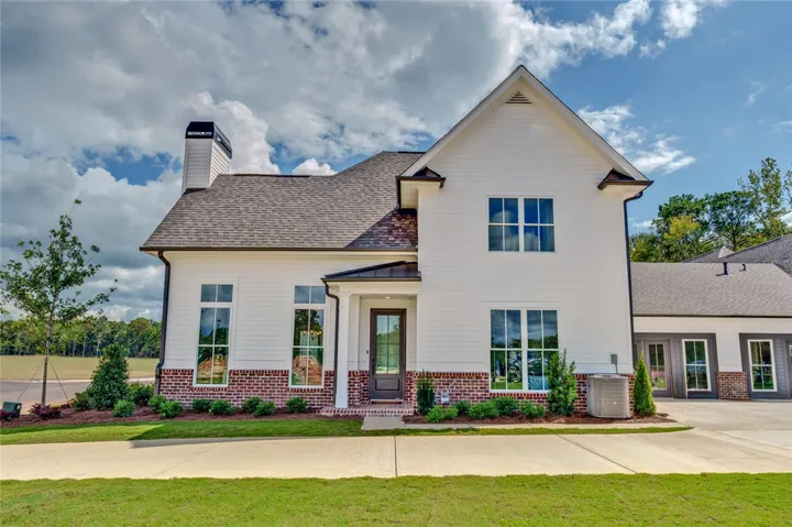 This appealing dwelling showcases charming brick and siding, featuring a welcoming entryway.