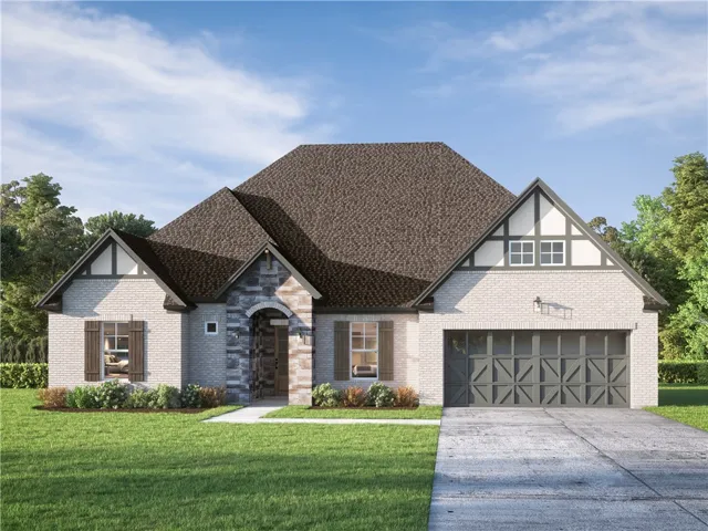 A charming single-story residence boasts a brick and stone facade with an attached garage and beautifully  landscaped!