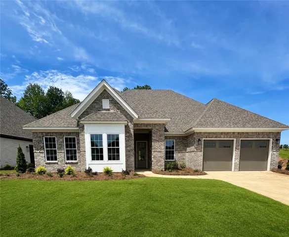 Symmetrical gables and detailed brickwork define the exterior of this modern single-family home.