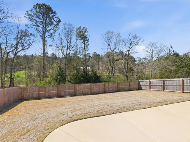 Backyard overlooks a private pond and natural woods