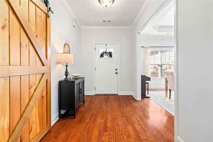 Wooden Barn door will be replaced with a white barn door