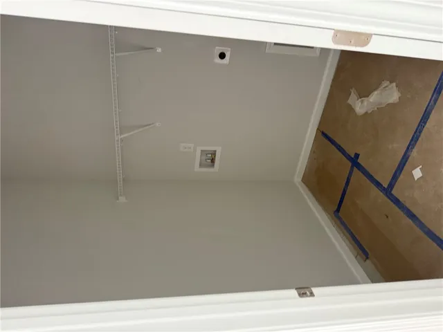 This dedicated laundry room provides essential hookups and a practical layout.