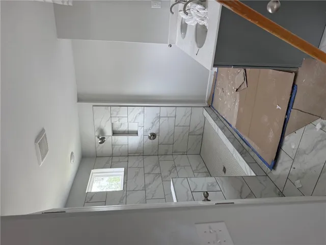 This modern bathroom features elegant tile work and a dual vanity, ready for personalized touches.