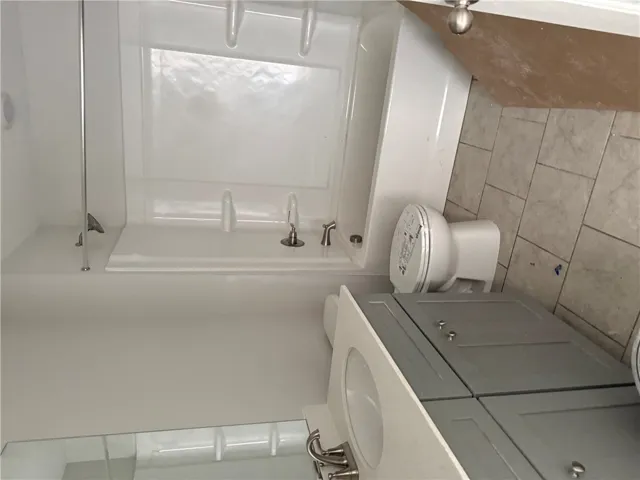 This bathroom features a contemporary vanity and a pristine shower, perfect for daily routines.