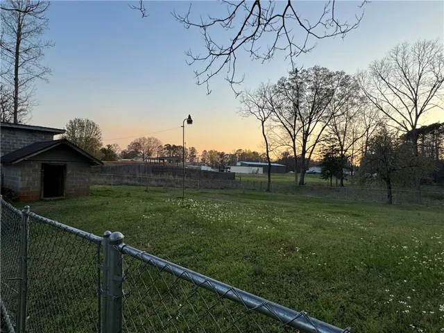 This expansive lot features a sturdy outbuilding and ample space, perfect for various outdoor pursuits.