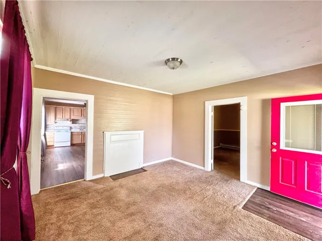 This versatile room offers flexible living options, connecting to the kitchen and entry.