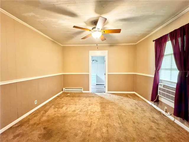 This bright room features a practical ceiling fan for comfortable living.