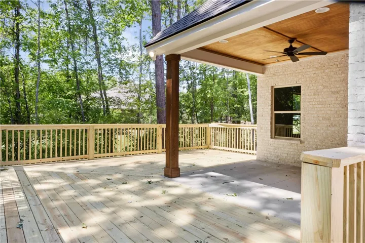 This outdoor deck offers a serene retreat surrounded by lush greenery.