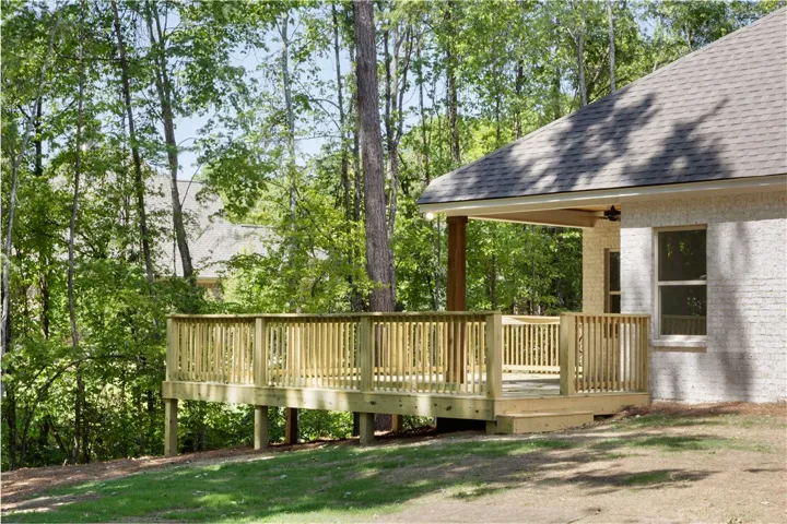 This newly constructed deck provides an idyllic outdoor retreat amidst nature.