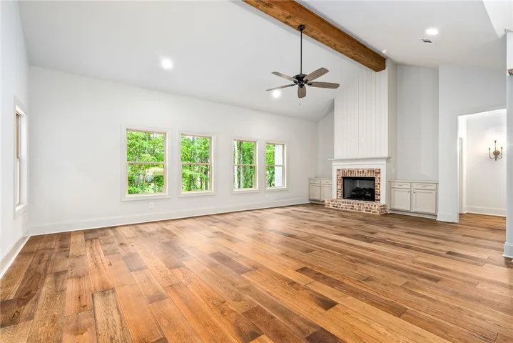 This expansive living area features a charming fireplace and abundant natural light.