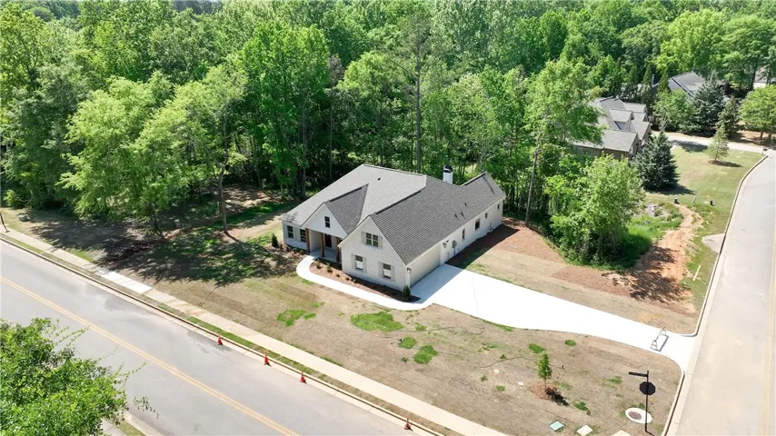 This charming home features a classic design with a spacious driveway.