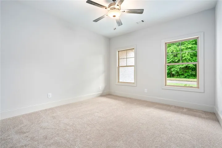 This spacious bedroom offers ample natural light and a comforting atmosphere.