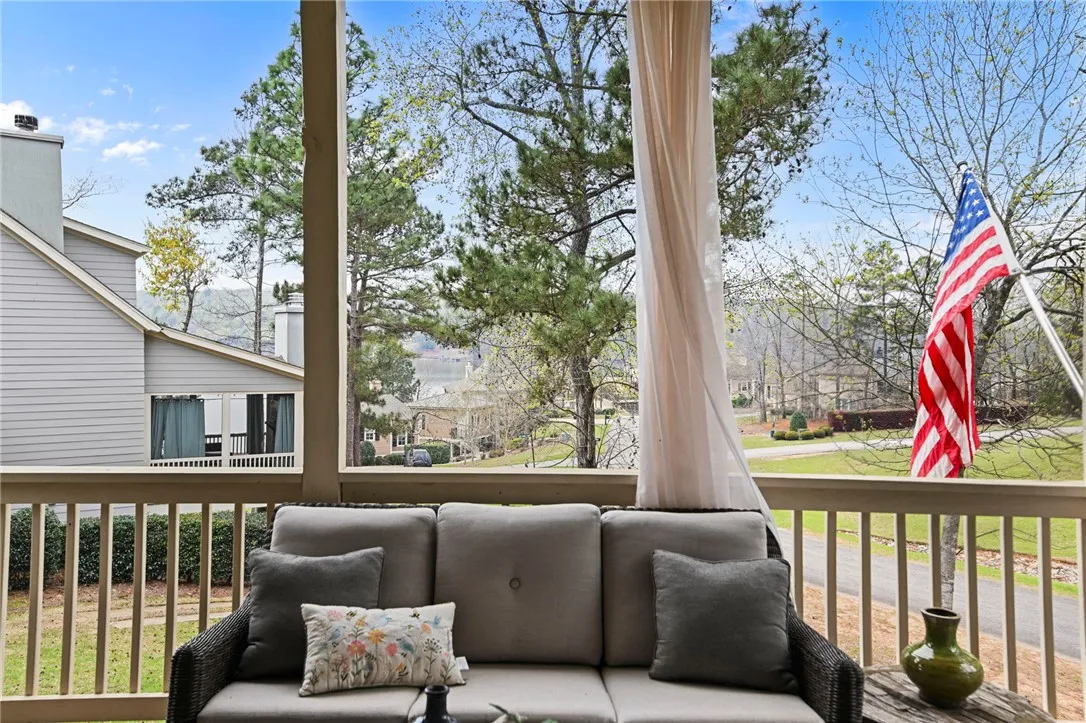 Enjoy tranquil lake views and lush surroundings from this inviting outdoor deck space.
