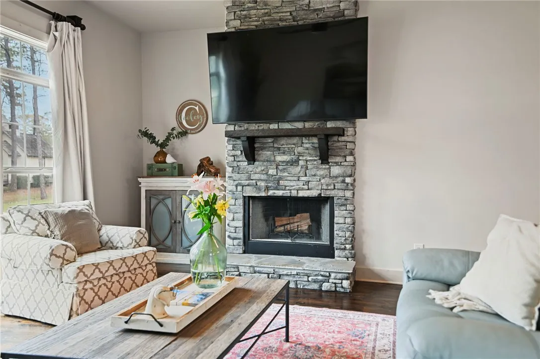 A striking stone fireplace creates a cozy ambiance in this inviting living space.