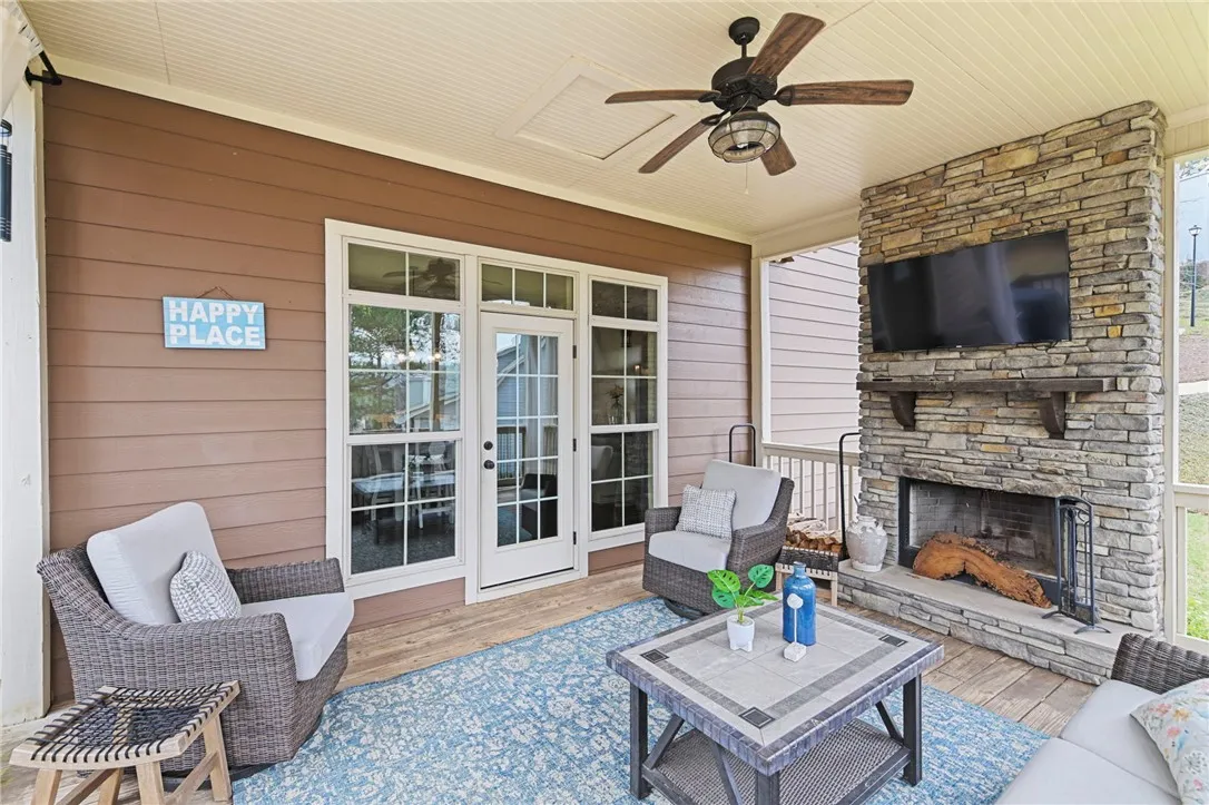 An inviting screened porch with a cozy fireplace awaits your relaxation.