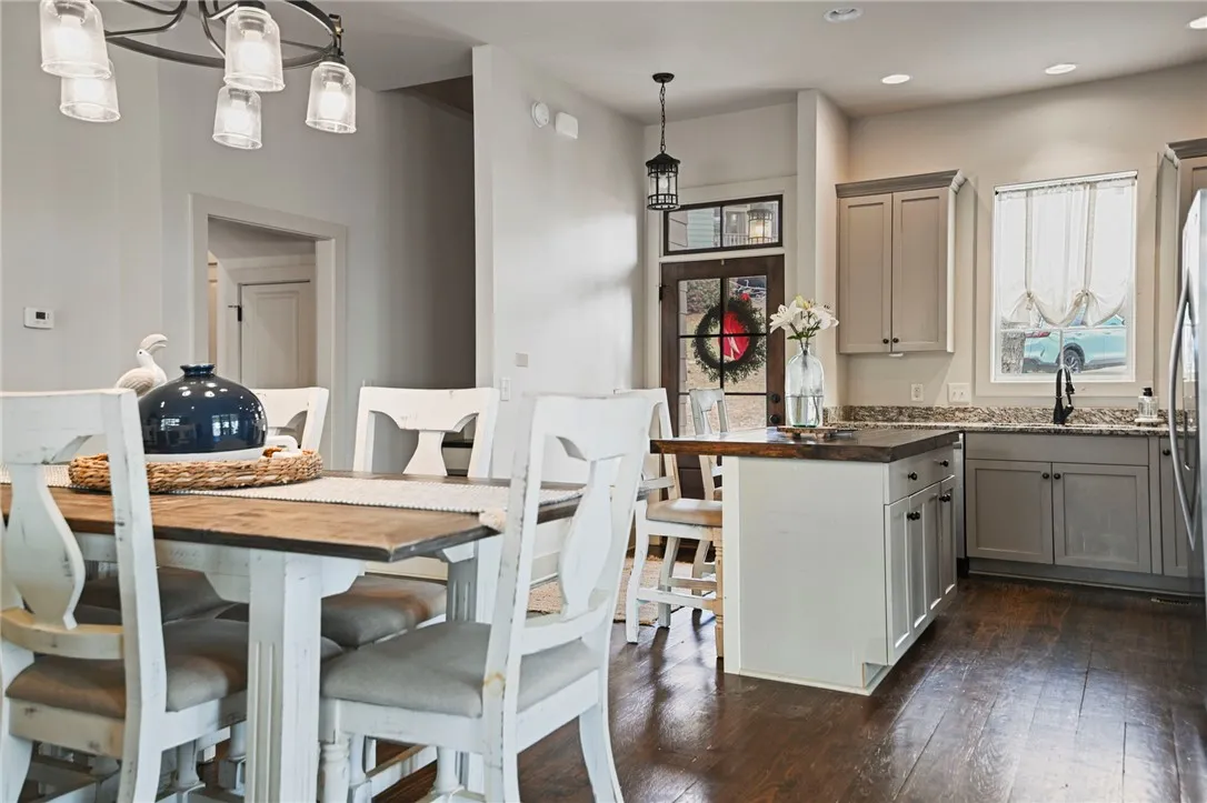 An inviting eat-in kitchen with a kitchen island and rich hardwood flooring, perfect for gatherings.