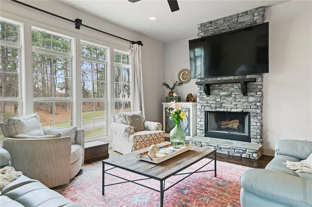 A comforting living space features a captivating stone fireplace, perfect for gathering.