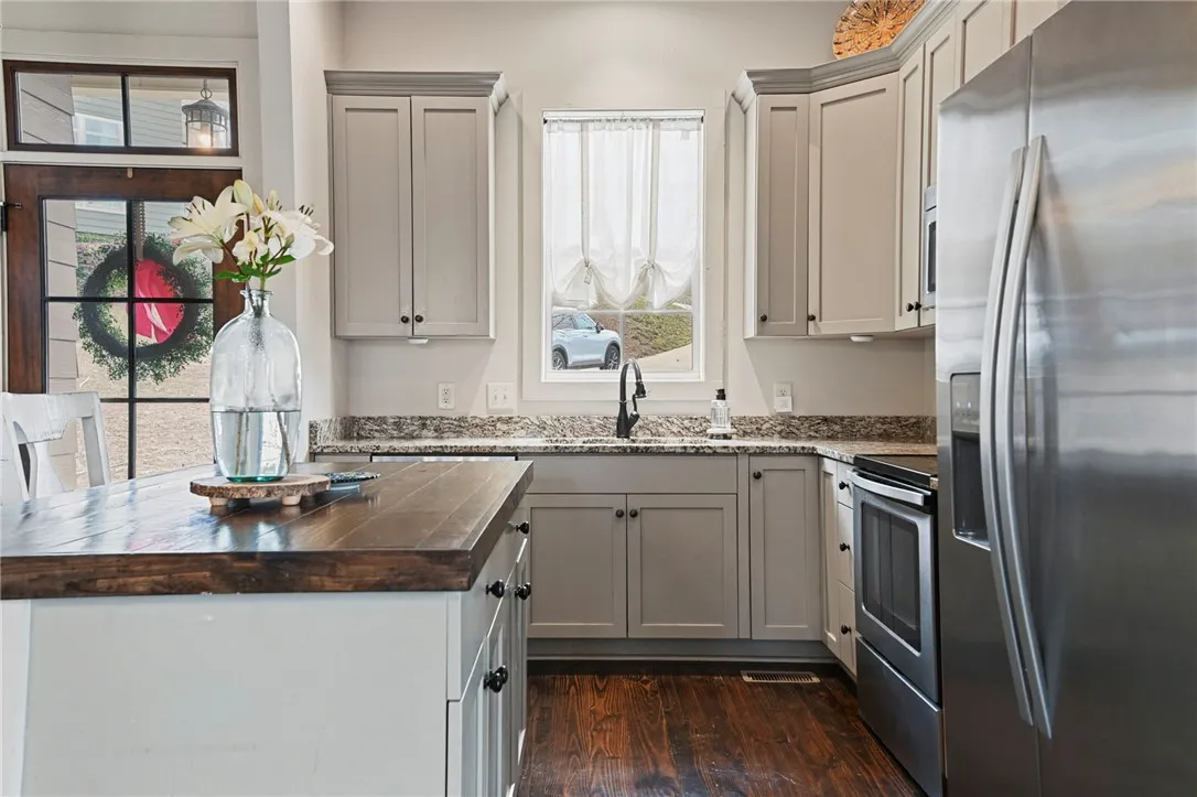 Culinary creations come to life in this kitchen, featuring rich hardwood floors and gleaming stainless steel appliances.