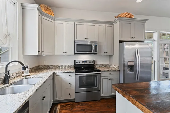 Culinary adventures await in this modern kitchen featuring granite counters and stainless steel appliances.