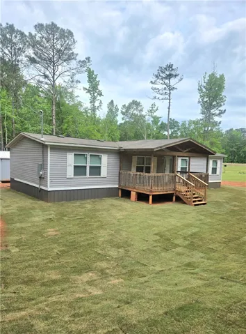 This charming home offers a welcoming front porch and spacious yard surrounded by mature trees.