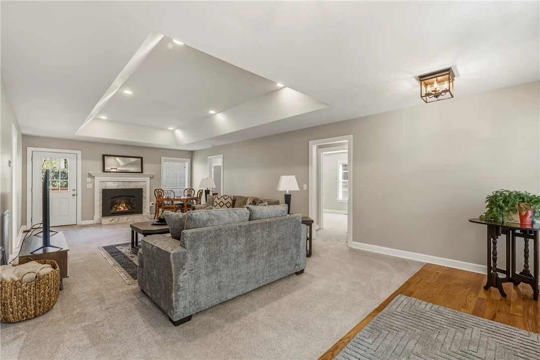 Expansive great room with tray ceiling and can lights