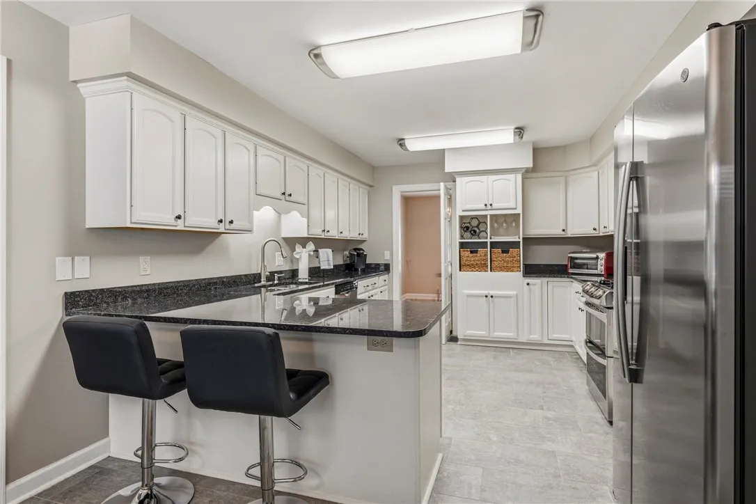 kitchen peninsula with breakfast bar for additional seating