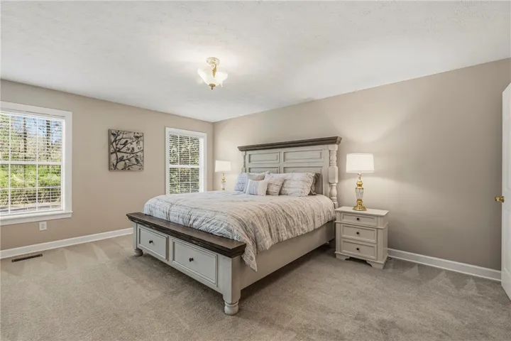 Bedroom 1 is the Primary Suite and it is located on one side of the home. This suite offers a large bedroom, private bath, walk in built in closet and a large office with exterior access.