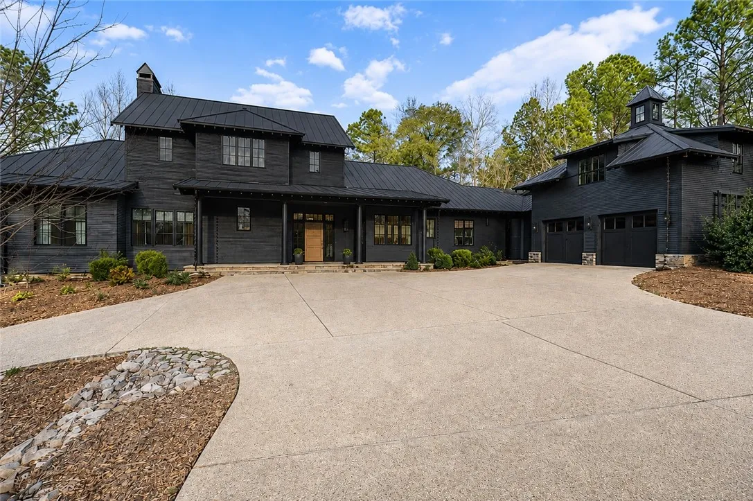 Winding drive with plentiful parking. Exterior is stone and Cypress.