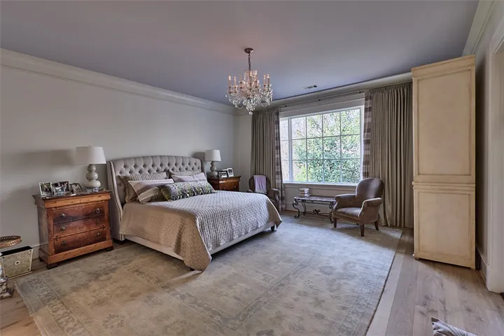 Primary bedroom. Door to back screen porch. Chandelier does not convey.