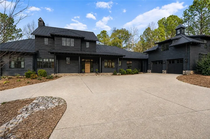 Winding drive with plentiful parking. Exterior is stone and Cypress.