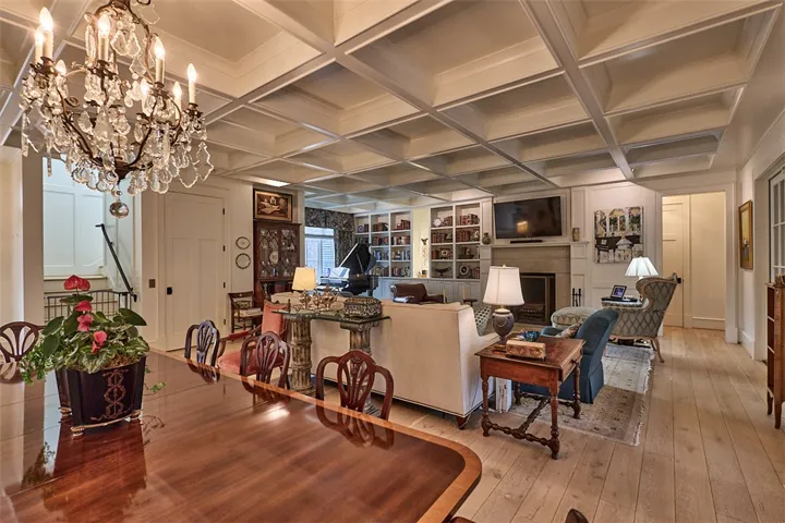What a ceiling! Cast stone fireplace. European white oak floors. Chandelier does not convey.