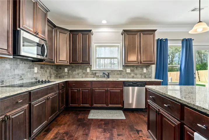 Tiled backsplash, ample storage, hardwood floors
