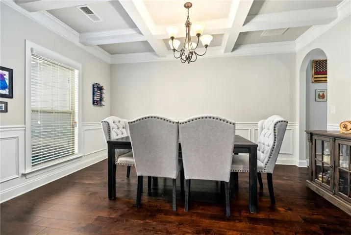 Formal dining room has judges paneling and coffered ceiling