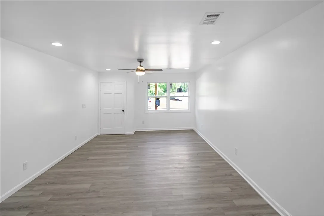 This bright, spacious living area offers comfort and style with durable flooring and ample natural light.