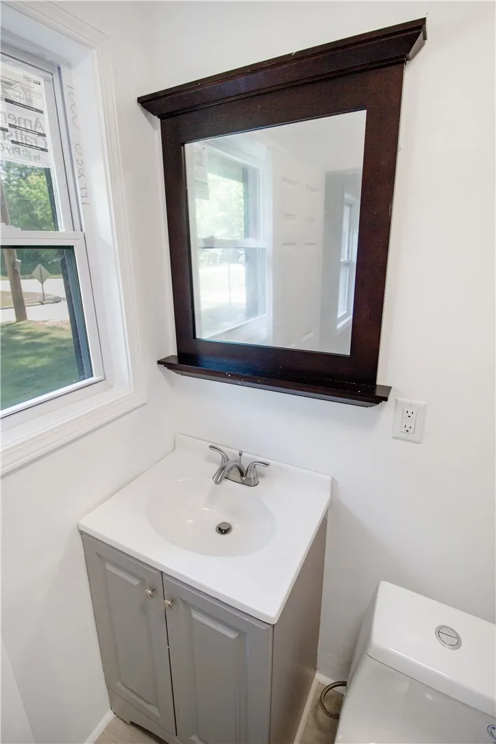 This clean and functional bathroom features a single vanity, offering practical elegance.