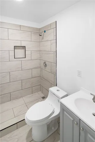 This newly updated bathroom features a spacious shower and contemporary vanity for modern comfort.
