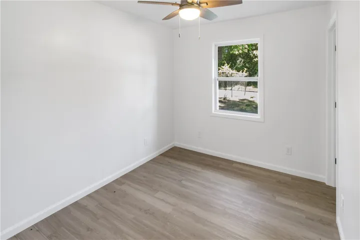 This bright room features beautiful flooring and abundant natural light.
