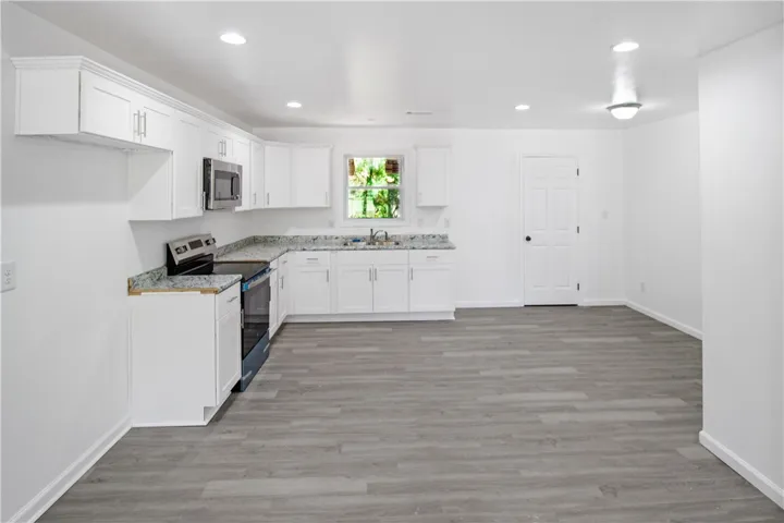 This spacious kitchen offers a seamless flow, ideal for culinary creations and entertaining.