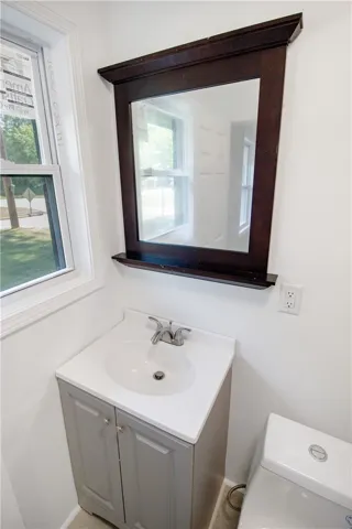 This clean and functional bathroom features a single vanity, offering practical elegance.