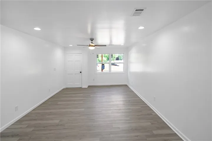 This bright, spacious living area offers comfort and style with durable flooring and ample natural light.