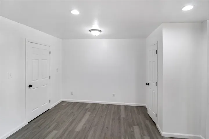 This spacious room offers versatile living with modern flooring and ample natural light.