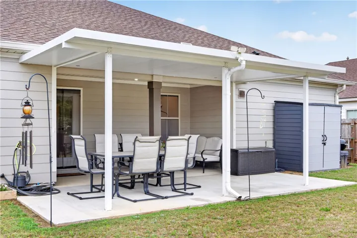 A spacious covered patio offers ample room for outdoor dining and relaxation.