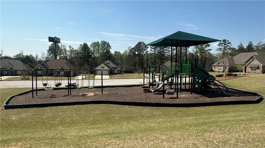 A community playground, perfect for recreation and family enjoyment, sits within a well-maintained neighborhood setting.
