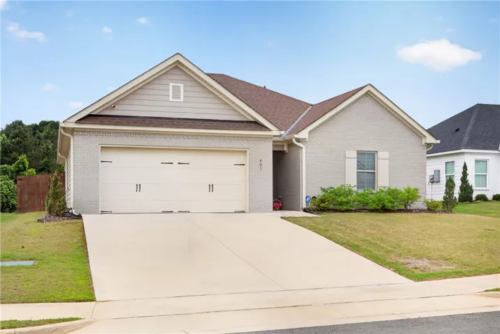 A clean, modern exterior with a concrete driveway and tidy landscaping, creating appealing curb appeal.