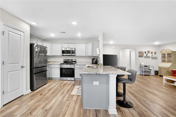 Culinary creations come to life in this kitchen, featuring an inviting island and elegant granite countertops.